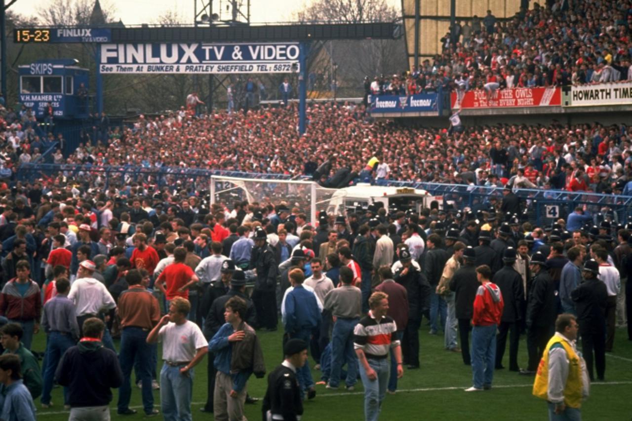 'Apr 1989:  Supporters are crushed against the barrier as disaster strikes before the FA Cup semi-final match between Liverpool and Nottingham Forest played at the Hillsborough Stadium in Sheffield, E