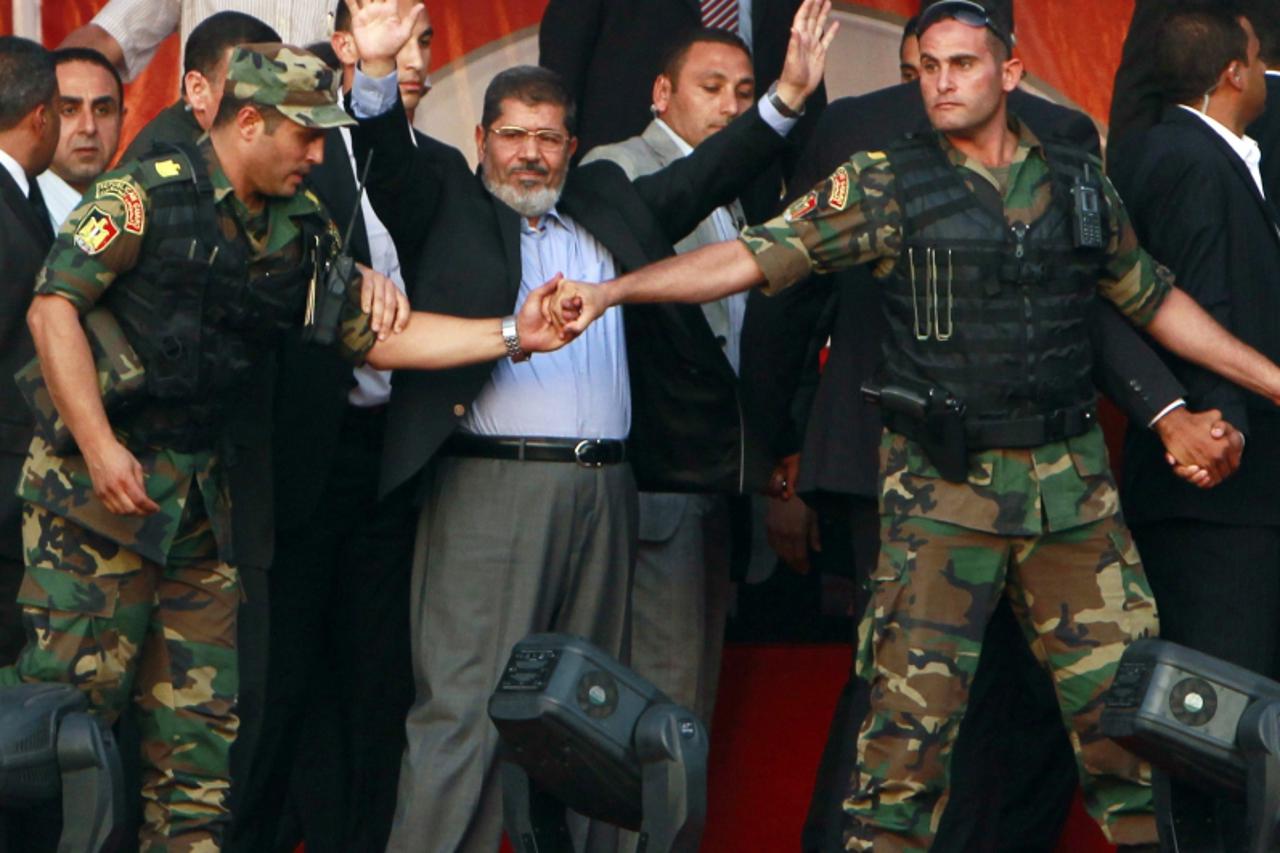 'RNPS IMAGES OF THE YEAR 2012 - Egypt's Islamist President-elect Mohamed Mursi waves to his supporters while surrounded by his members of the presidential guard in Cairo's Tahrir Square, June 29, 20