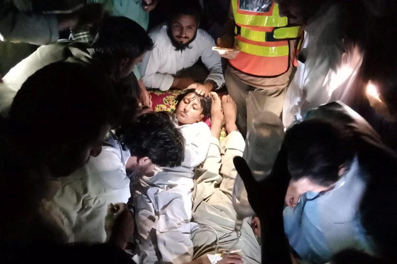 Children receive first aid after they were rescued from the stranded chairlift, in Battagram