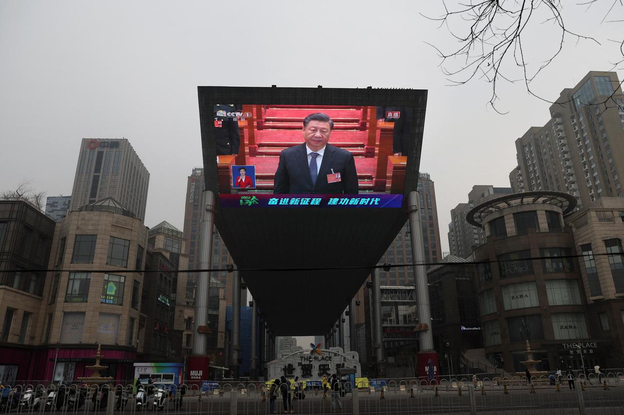 Giant screen shows Chinese President Xi Jinping attending the closing session of the National People's Congress (NPC) at the Great Hall of the People, in Beijing