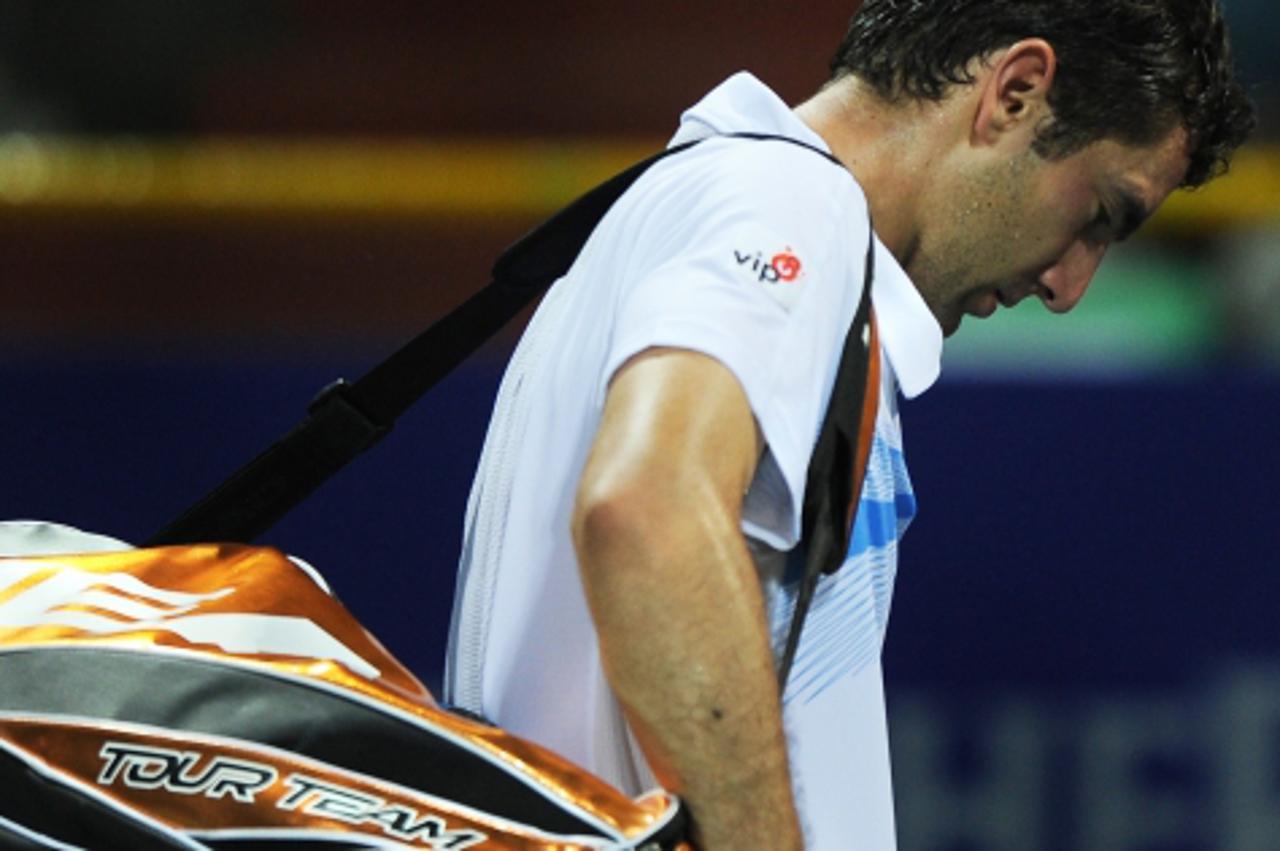 'Croatian tennis player Marin Cilic walks out of the court after loosing against his Japanese opponent Kei Nishikori, after their first round match at the ATP Chennai Open 2011, in Chennai on January 