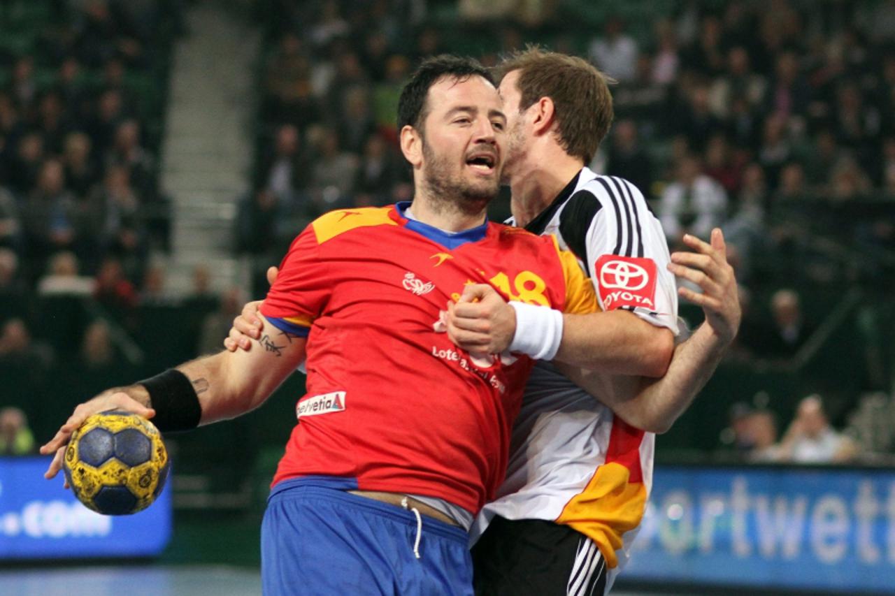 'Spain\'s Iker Romero gets through during the Supercup handball match Germany vs Spain at Gerry Weber Stadium in the western German city of Halle on November 6, 2011. AFP PHOTO / OLIVER KRATO  GERMANY