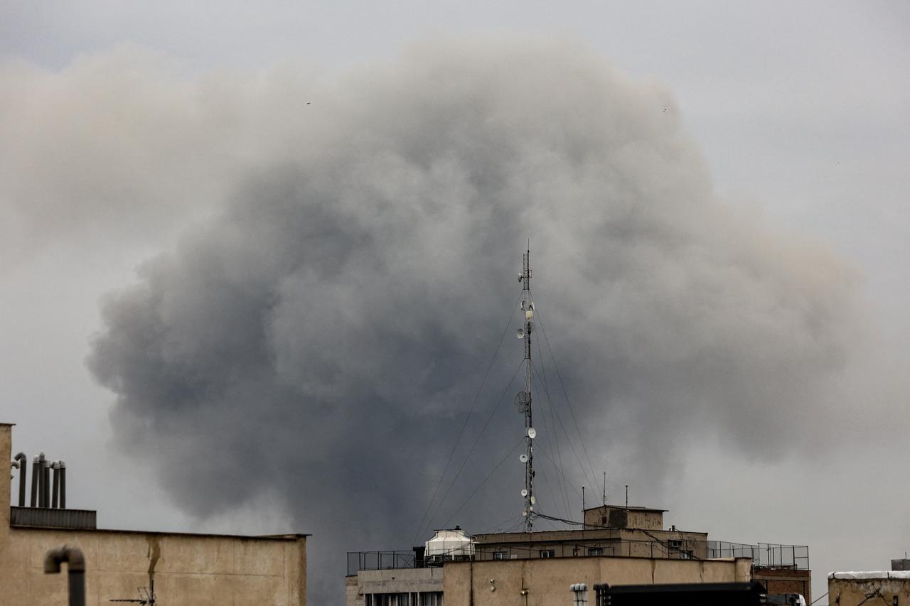Smoke rises following a strike, in Tehran