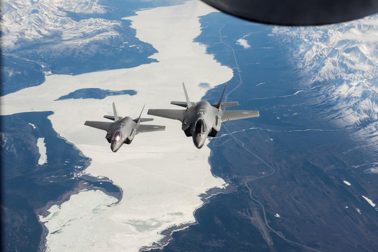 Two U.S. Air Force F-35A Lightning II fighter aircraft fly over the Alaska-Canada Highway