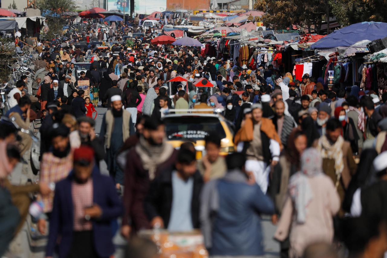 People walk in a street in Kabul