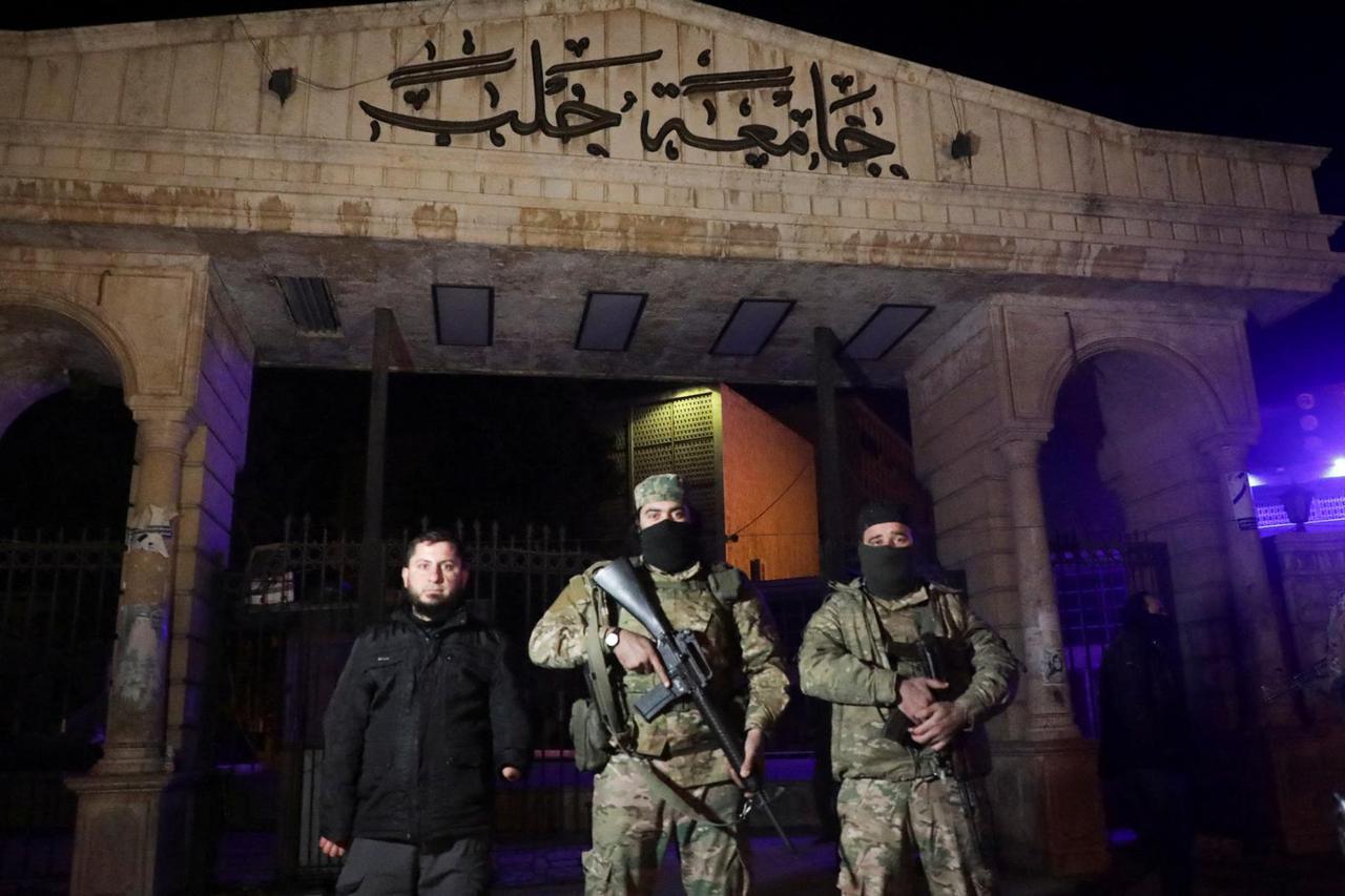 Syrian opposition fighters stand in front of University of Aleppo, after rebels opposed to President Bashar al-Assad said they had reached the heart of Aleppo