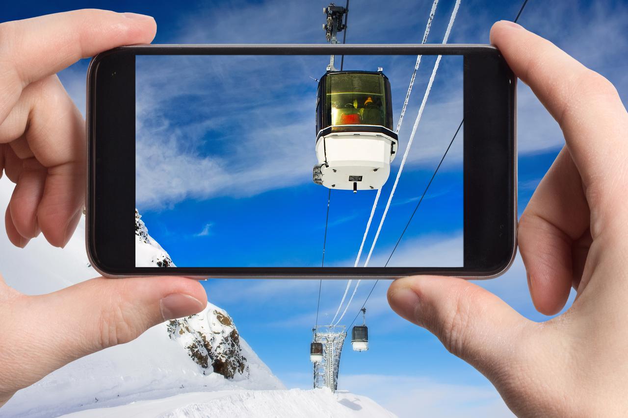 Wire-rope way at the winter mountains in a mobile phone