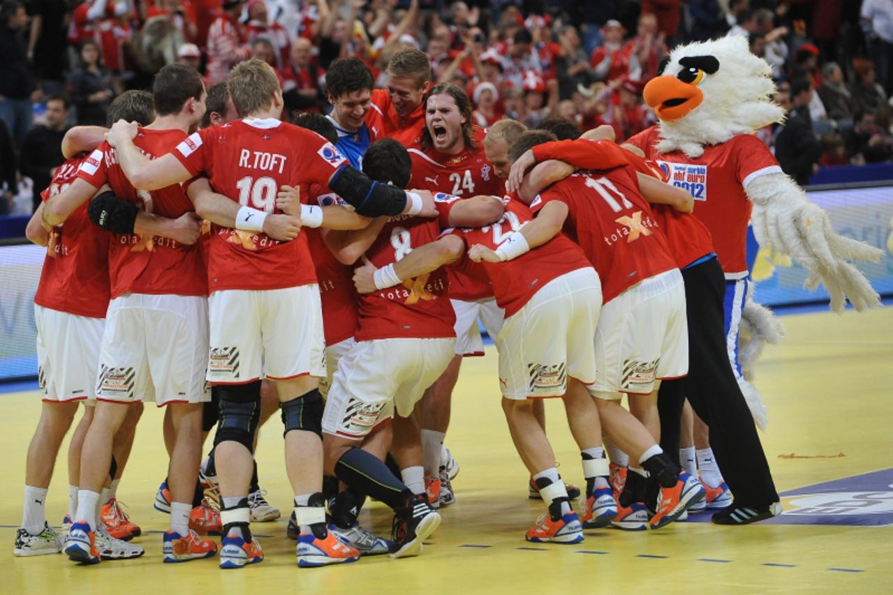 'Denmark\'s players celebrate their victory in the men\'s EHF Euro 2012 Handball Championship match Denmark vs Sweden on January 25, 2012 at the Belgrade Arena.   AFP PHOTO / ANDREJ ISAKOVIC'