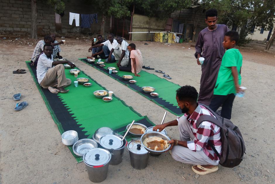 Displaced Sudanese prepare to break their fast at a displacement camp during the month of Ramadan, in the city of Port Sudan