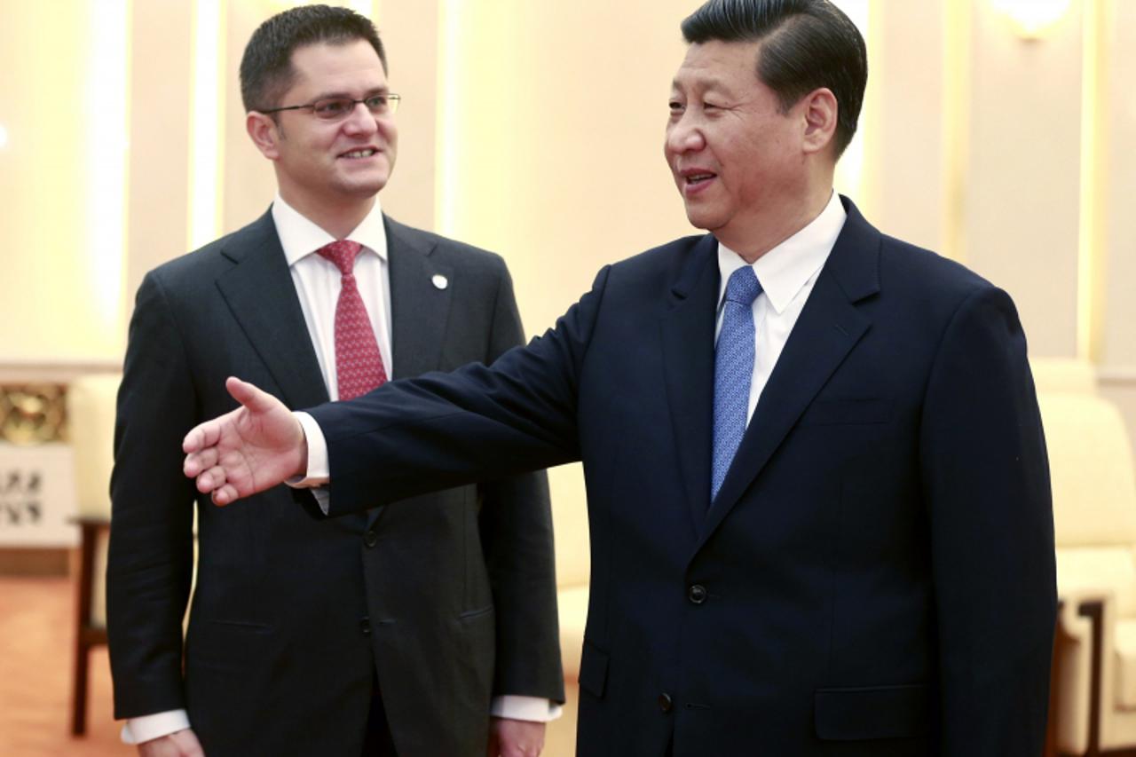 'General Secretary of the Central Committee of the Communist Party of China (CPC) Xi Jinping (R) gestures to the President of the United Nations General Assembly Vuk Jeremic of Serbia during a meeting