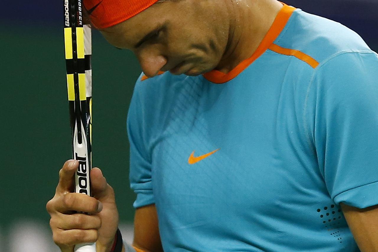 Rafael Nadal of Spain reacts after losing a point during his men's singles tennis match against Feliciano Lopez of Spain at the Shanghai Masters tennis tournament in Shanghai October 8, 2014. REUTERS/Aly Song (CHINA - Tags: SPORT TENNIS)