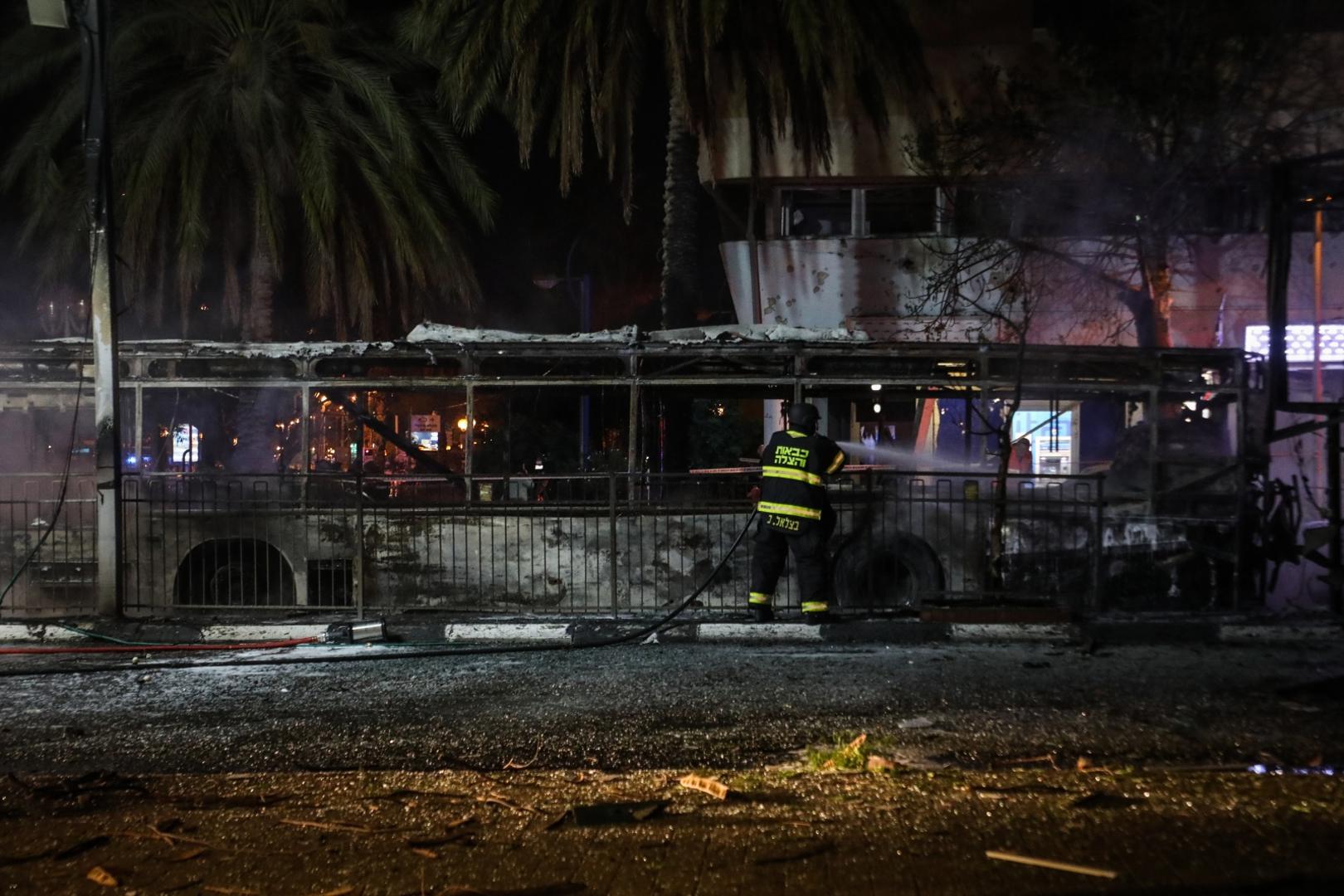 11 May 2021, Israel, Holon: An Israeli firefighter hoses down a burnt bus, after it was hit by a rocket fired by the Palestinian Islamist movement Hamas from Gaza towards Israel amid the escalating flare-up of Israeli-Palestinian violence. Photo: Oren Ziv/dpa /DPA/PIXSELL