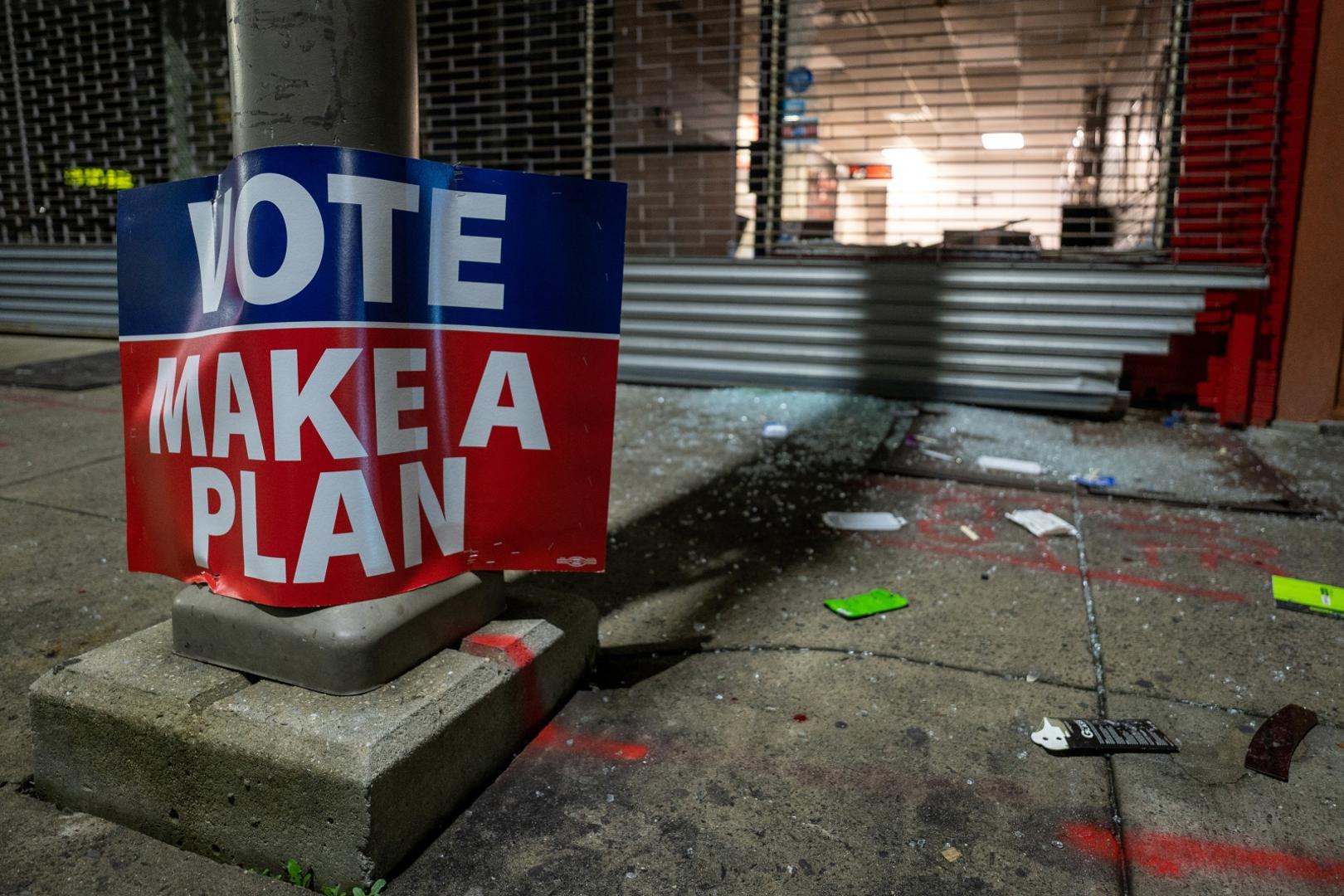Protests flare in Philadelphia after police fatally shoot Black man A sign that reads "Vote - make a plan" is seen outside of a looted cellphone store following protests over the police shooting death of Walter Wallace in Philadelphia, Pennsylvania, U.S., October 27, 2020.  REUTERS/David 'Dee' Delgado DAVID DELGADO