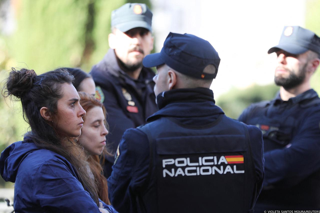 Police officers hold three Femen activists during a gathering to commemorate the 47th anniversary of the death of Spanish dictator Francisco Franco