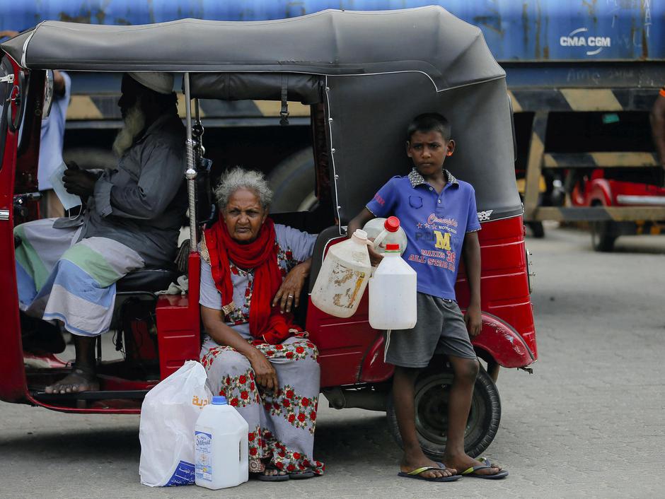 People queue to buy kerosene at a fuel station in Colombo