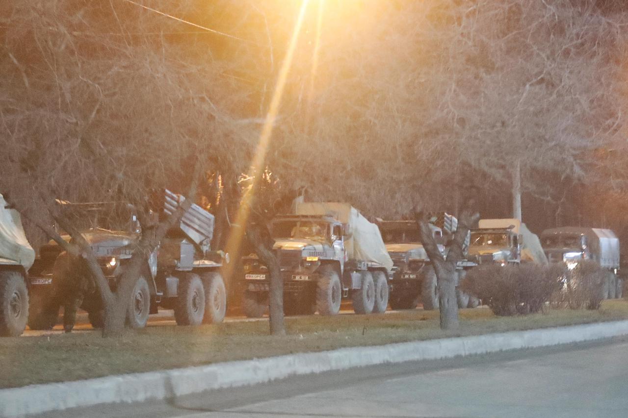 Military vehicles are seen on a street on the outskirts of Donetsk