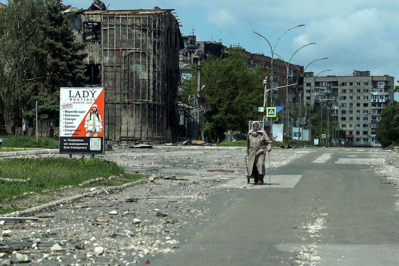 FILE PHOTO: A resident walks at a street near buildings in the frontline town of Pokrovsk