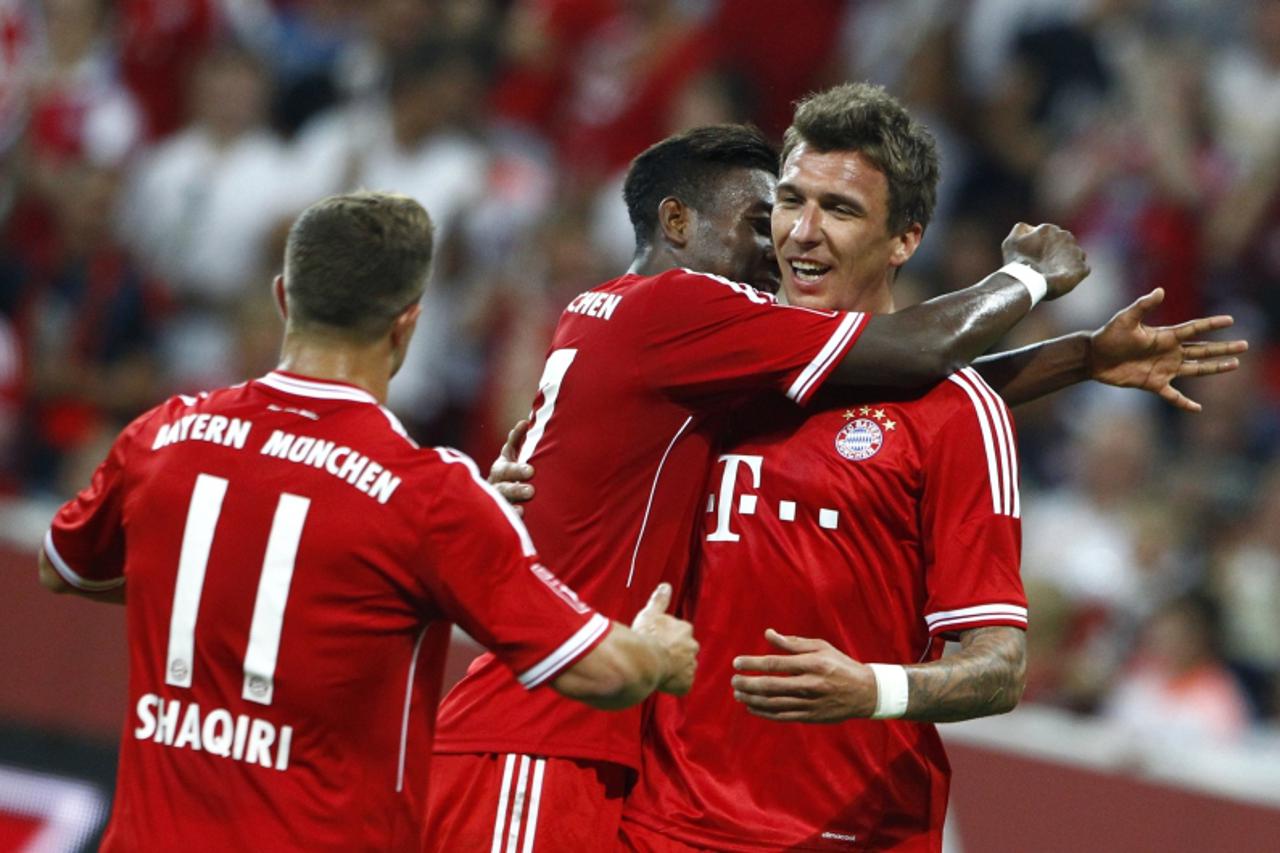 'Bayern Munich's players (L-R) Xherdan Shaqiri, David Alaba and Mario Mandzukic celebrate a goal against Manchester City during their final match at the Audi Cup friendly soccer tournament in Munich 