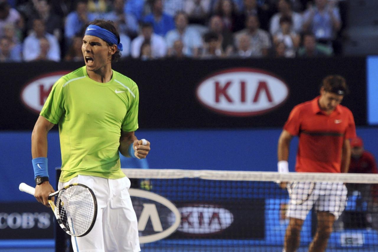 'Rafael Nadal of Spain celebrates winning a point against Roger Federer of Switzerland during their men\'s singles semi-final match at the Australian Open tennis tournament in Melbourne January 26, 20