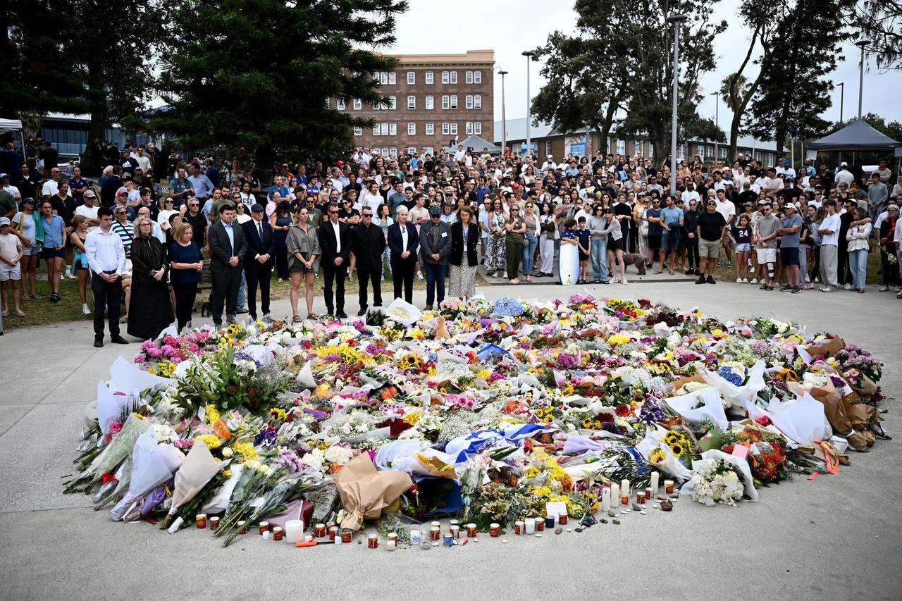 Mourners place flowers at a memorial at Bondi Beach in Sydney