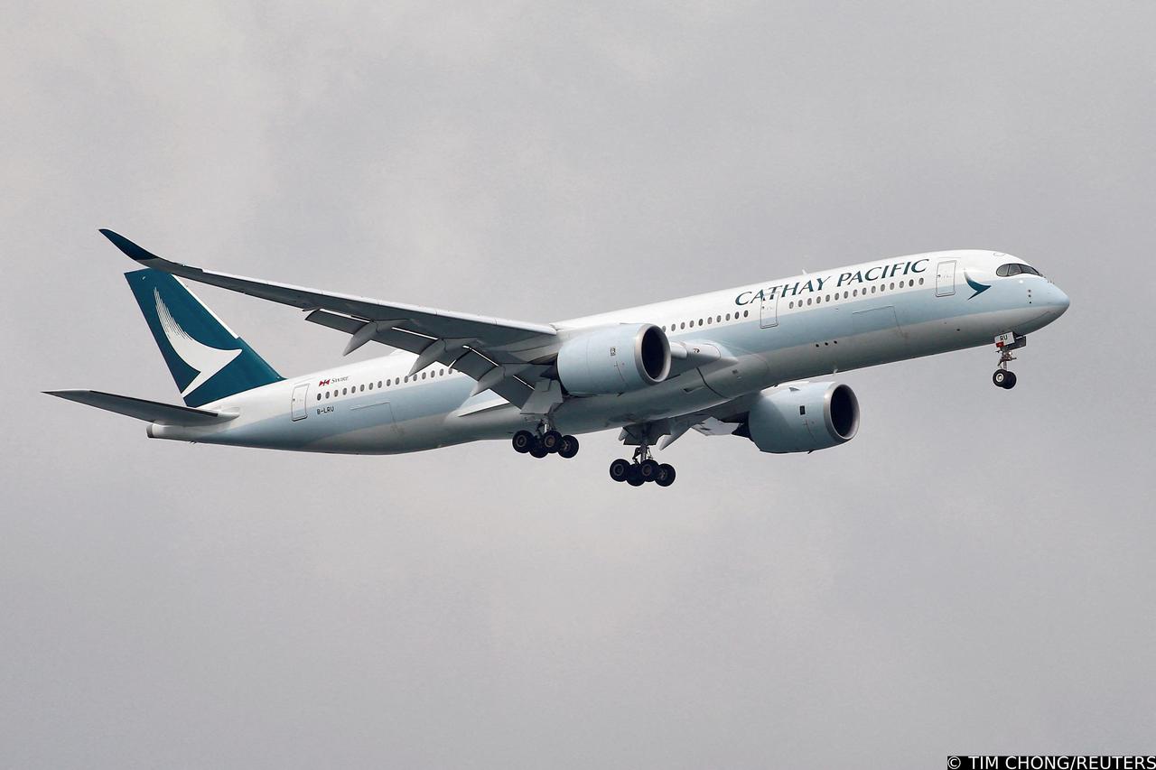 FILE PHOTO: A Cathay Pacific Airways Airbus A350 airplane approaches to land at Changi International Airport in Singapore