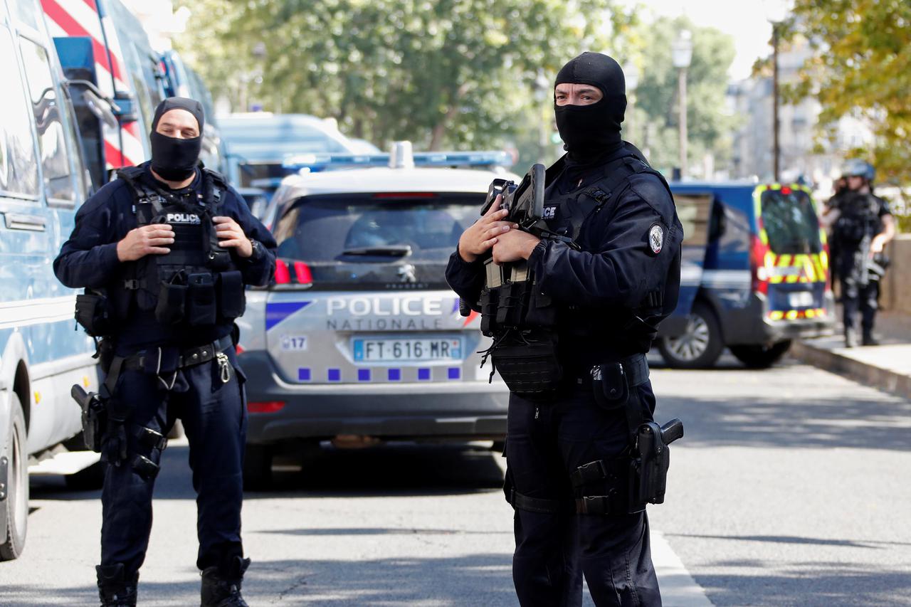 French police forces are seen near the Paris courthouse on the Ile de la Cite in Paris