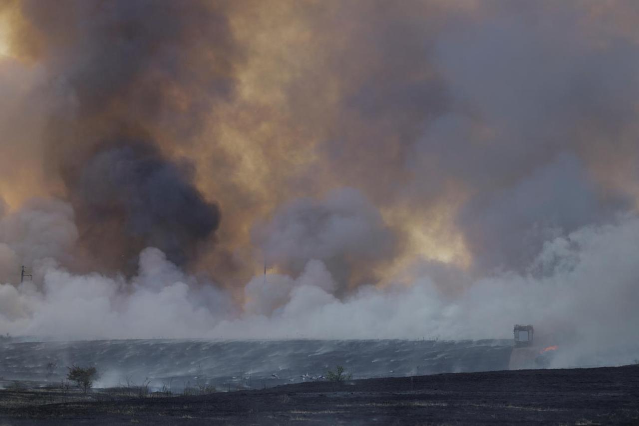 Smoke rises from a fire in a field after a Russian missile strike outside of Mykolaiv
