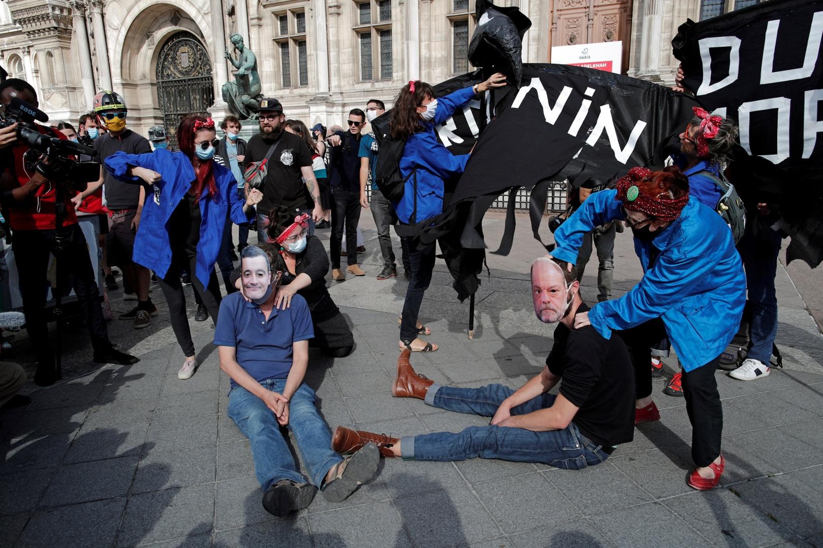 Feminist activists demonstrate against new government appointments in Paris Feminist activists wear masks depicting French Interior Minister Gerald Darmanin and Justice Minister Eric Dupond-Moretti during a demonstration against their appointments in the new French government, in front of the city hall in Paris, France, July 10, 2020. REUTERS/Benoit Tessier BENOIT TESSIER