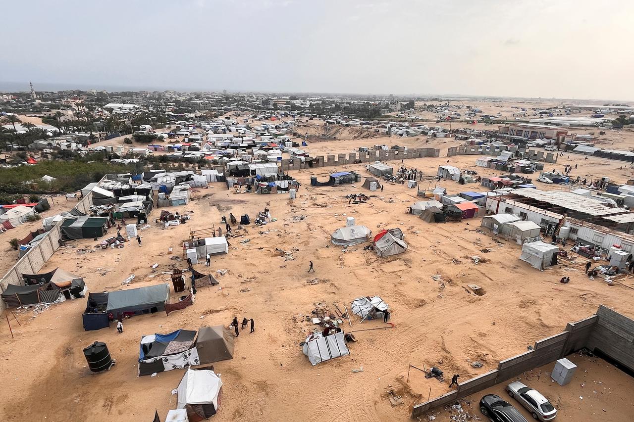 Displaced Palestinians prepare to evacuate a tent camp, after Israeli forces launched a ground and air operation in the eastern part of Rafah