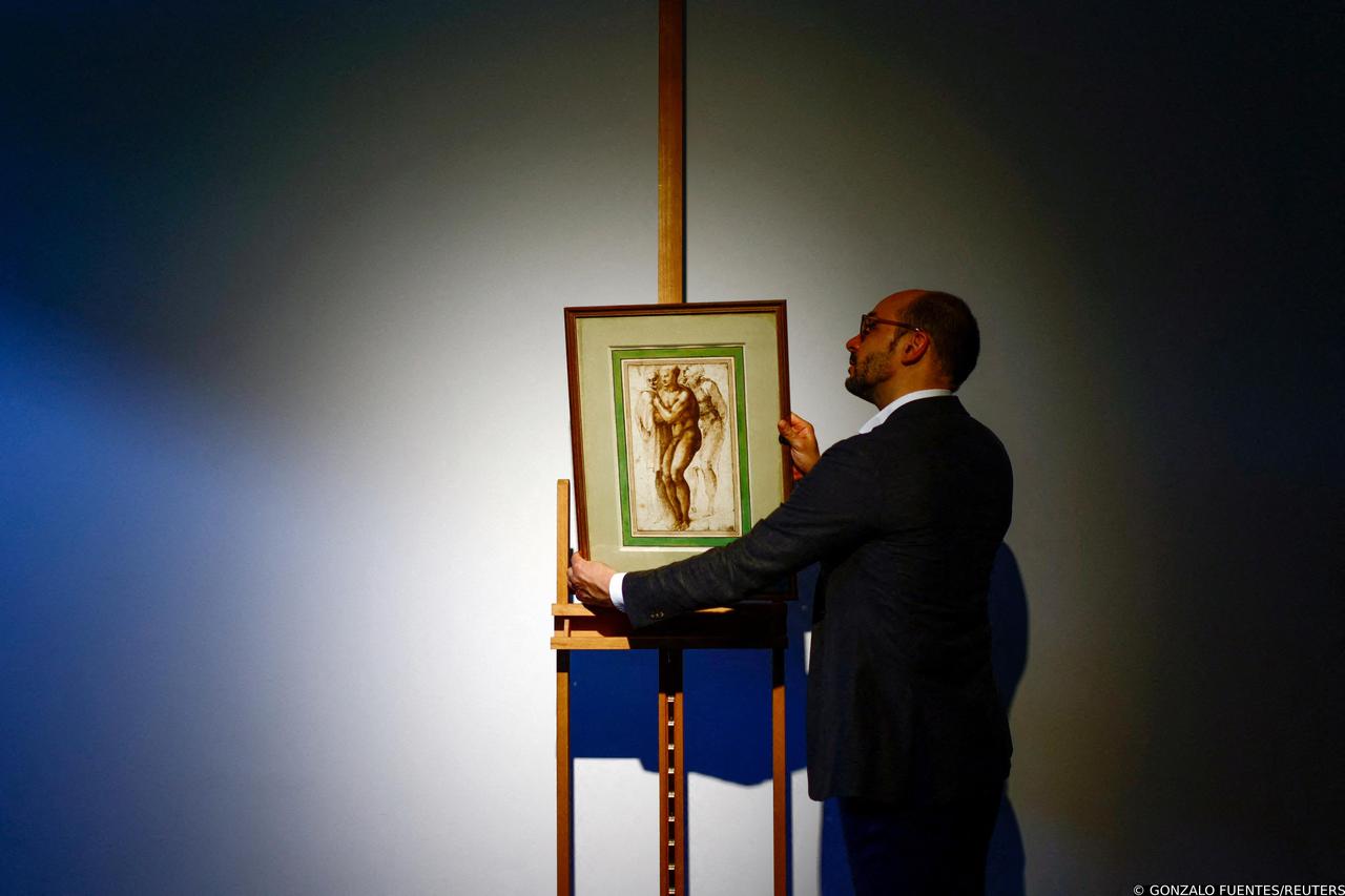 The drawing "A nude young man (after Masaccio) surrounded by two figures" by Michelangelo on display before its auction in Paris