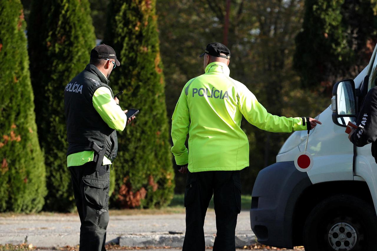 Slovakian police check a vehicle at the Slovakia-Hungary border in Sahy