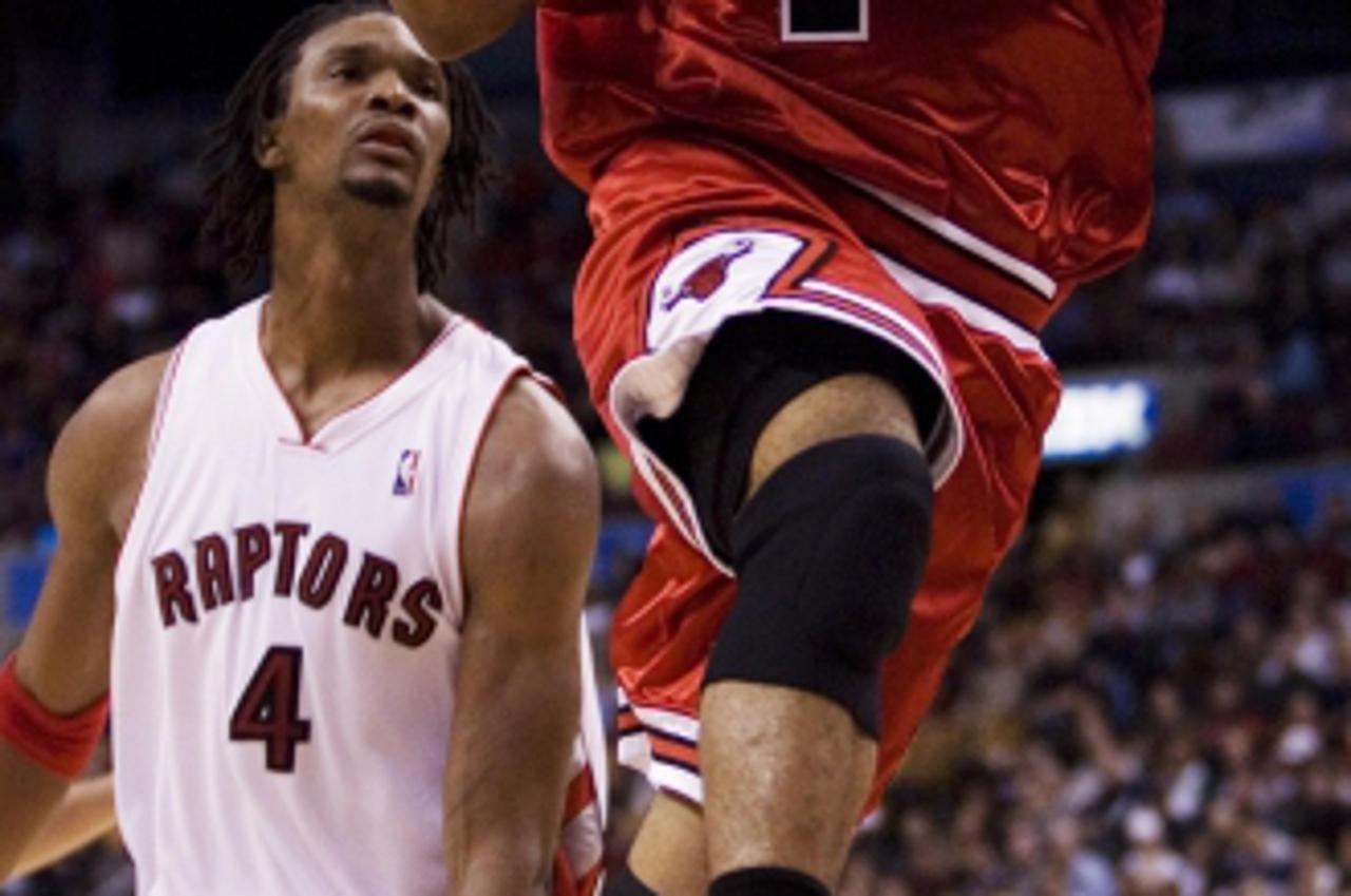 'NBA Bulls Raptors Basketball Chicago Bulls\' Derrick Rose (1) drives to the basket as Toronto Raptors\' Chris Bosh (4) looks on during the fourth quarter of an NBA basketball game in Toronto on Sunda