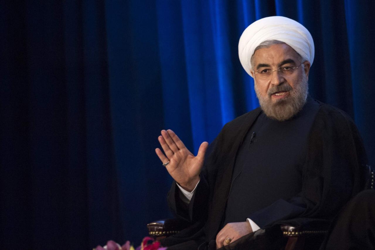 'Iran\'s President Hassan Rohani speaks with Asia Society President and CEO Josette Sheeran during an event hosted by the Council on Foreign Relations and the Asia Society in New York, September 26, 2