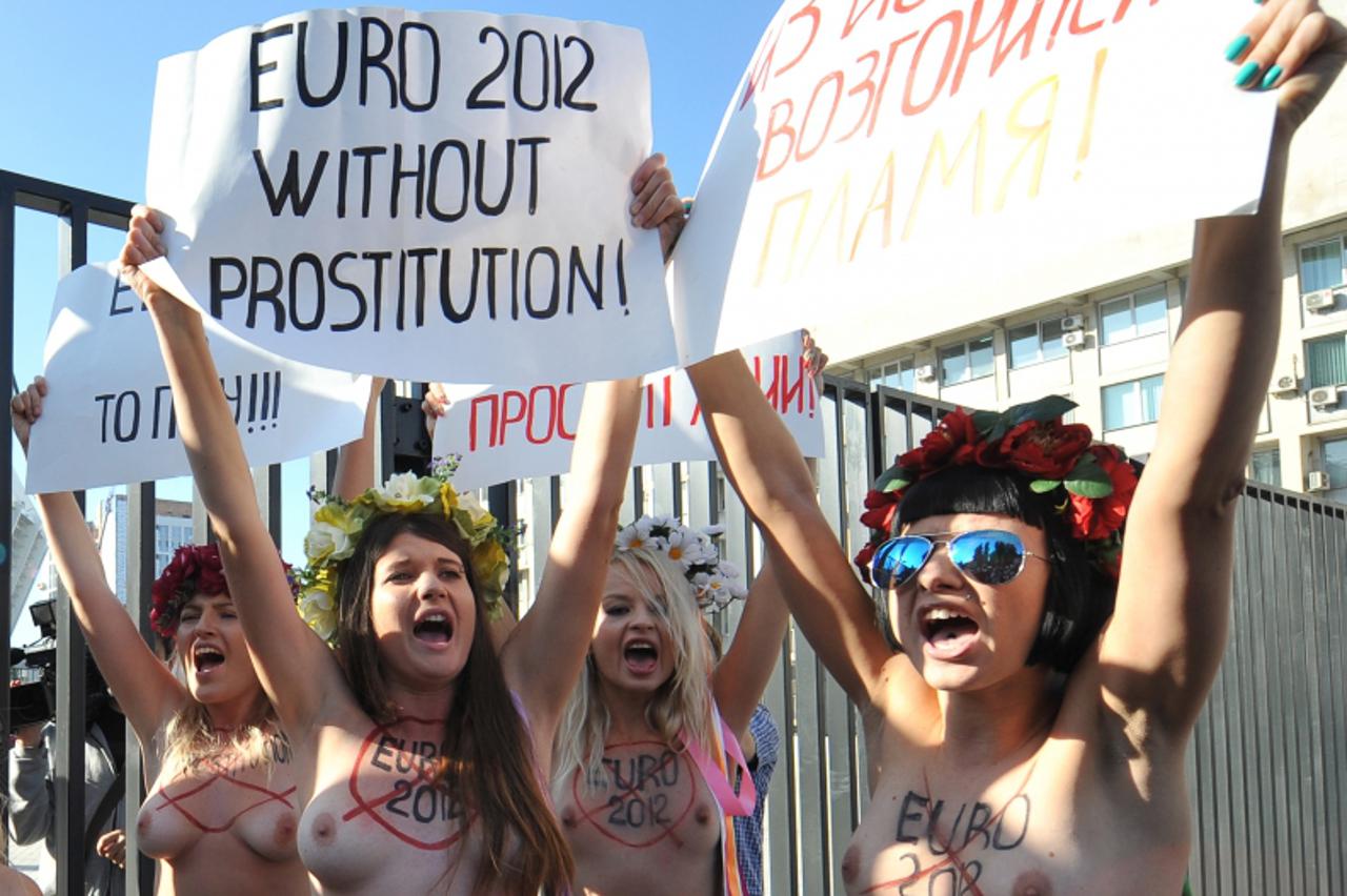 'Activists of Femen, a Ukrainian women\'s movement, protest in front of the  Olympiysky stadium in Kiev on September 27, 2011. UEFA President Michel Platini is in the Ukraine for a two-day visit to in