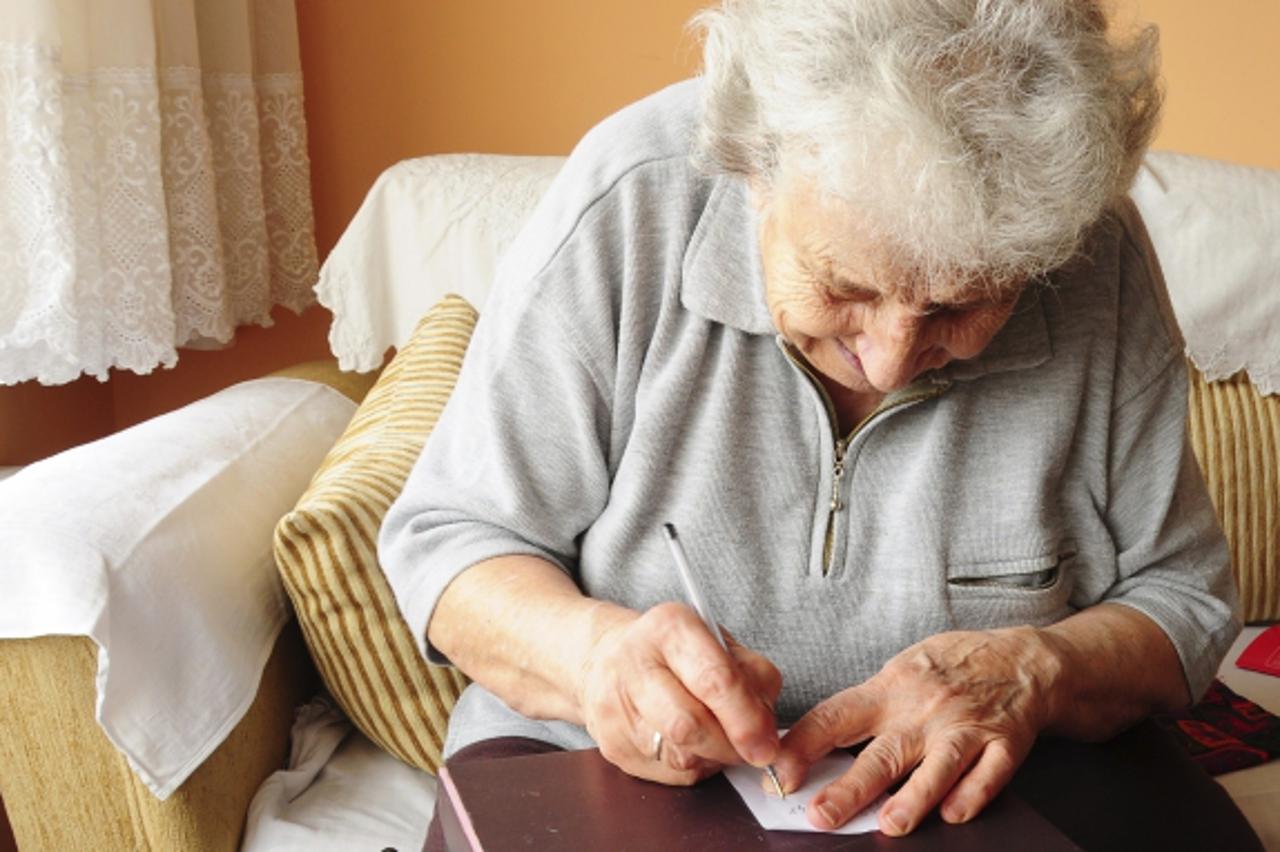 \'old woman writing\'