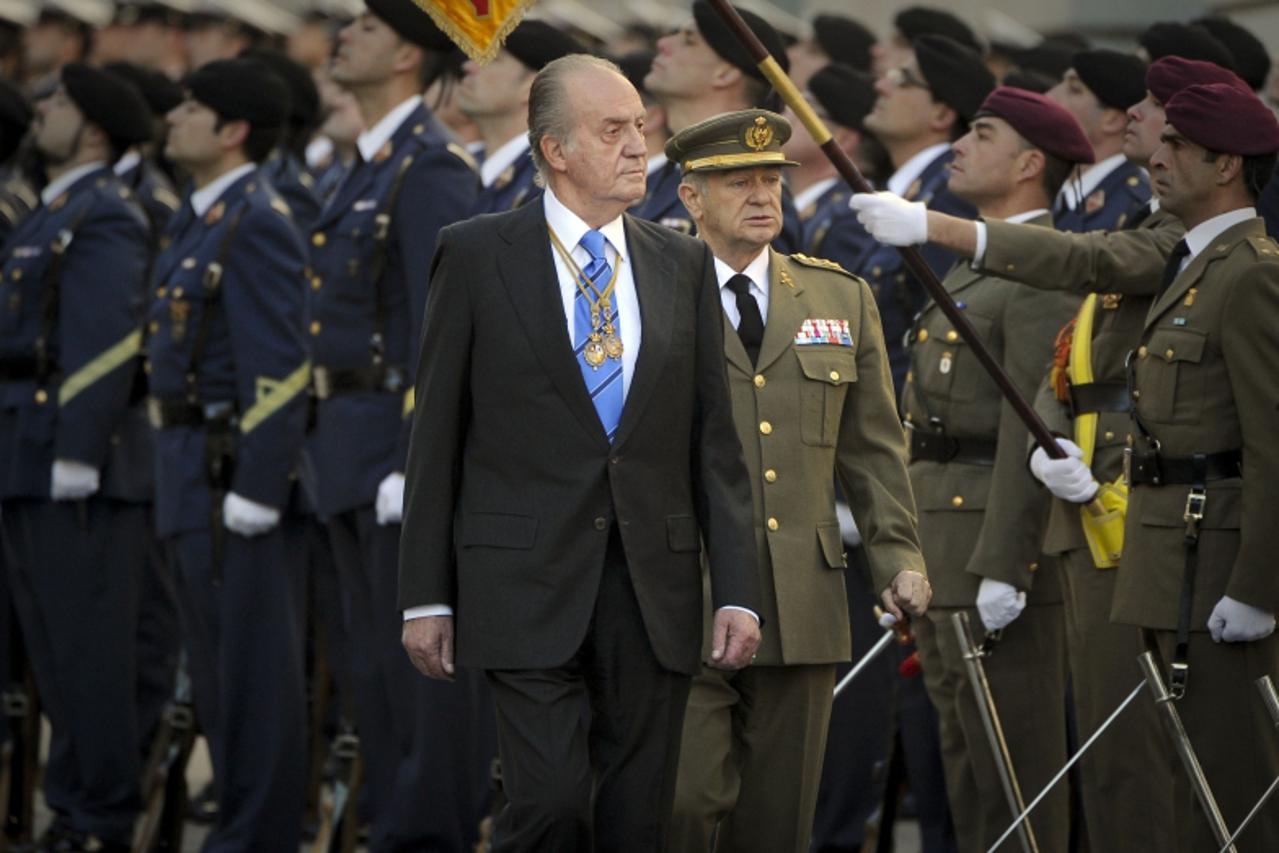 'Spanish King Juan Carlos reviews the troops before launching the new parliament in Madrid on December 27, 2011.  Juan Carlos declared the parliament open Tuesday with a solemn plea for an effort to r