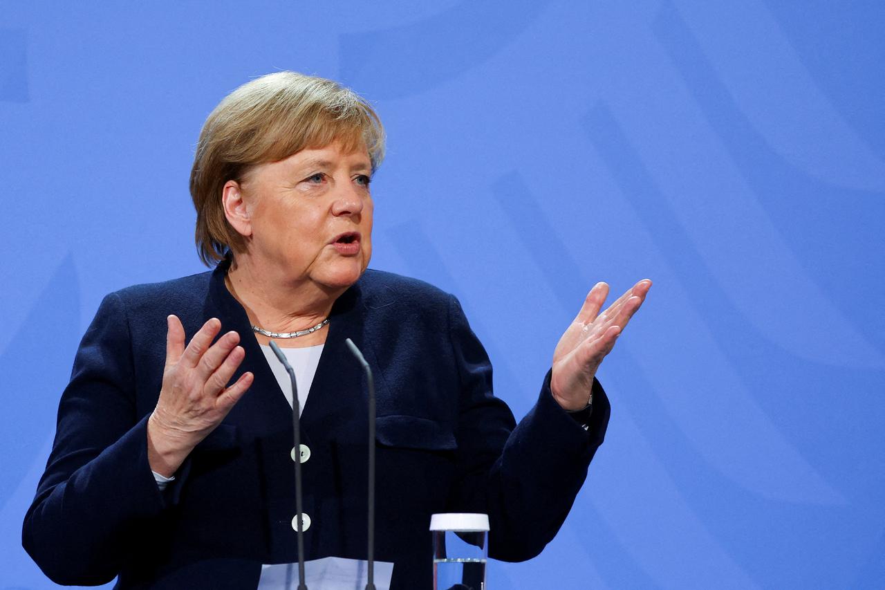 FILE PHOTO: Former German Chancellor Merkel bids farewell to her successor Scholz in Berlin