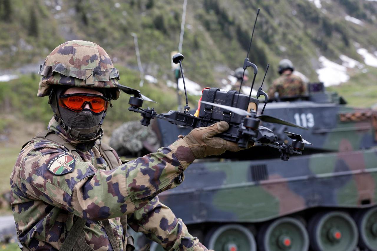 A Swiss army drone operator controls a first person view drone during a presentation of usage of small drones at an army facility in Elm