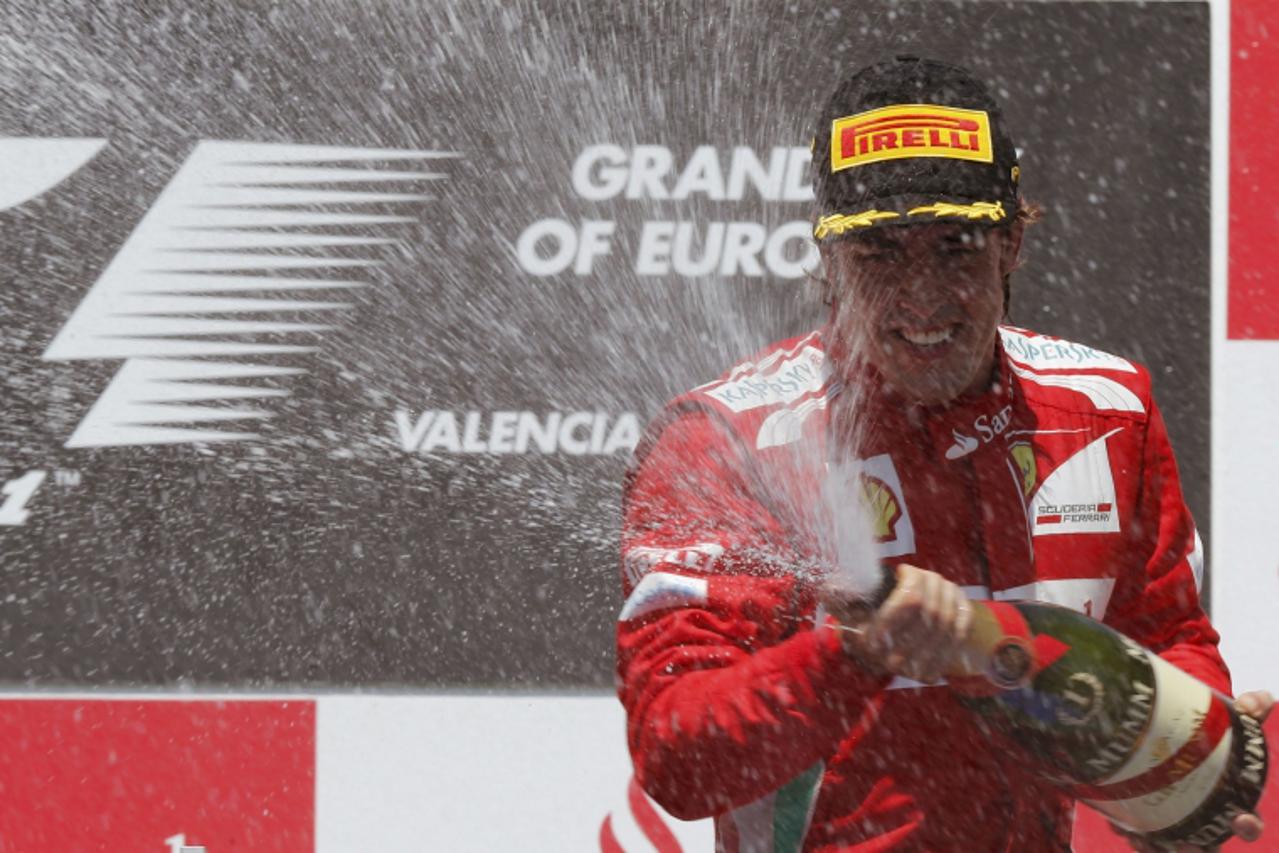 'Ferrari Formula One driver Fernando Alonso of Spain sprays champagne during the podium ceremony after the European F1 Grand Prix at the Valencia street circuit June 24, 2012. Alonso won the European 