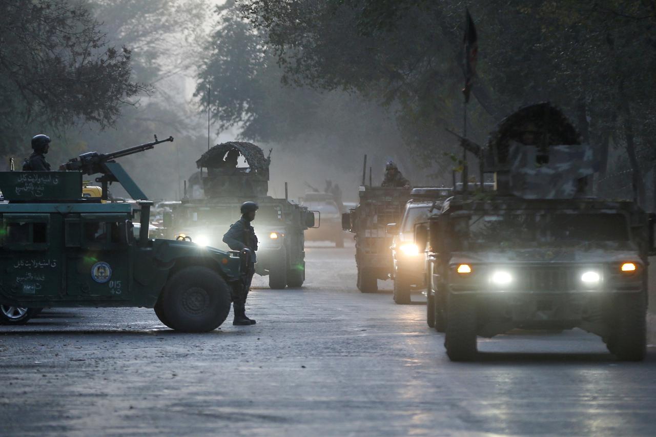Afghan security forces leave the site of an incident after an attack at the university of Kabul
