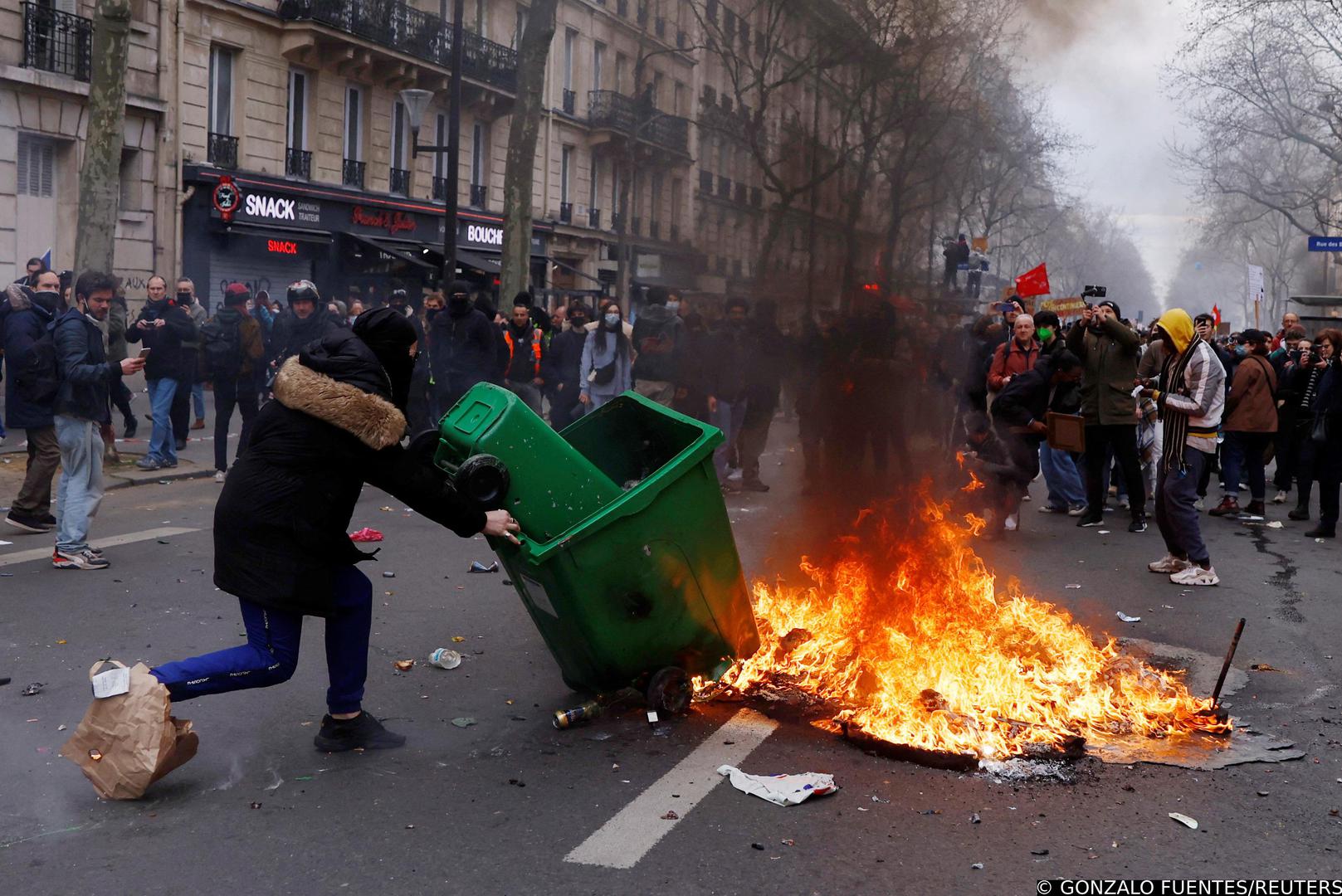 A protester sets a garbage bin on fire during clashes at a demonstration as part of the tenth day of nationwide strikes and protests against French government's pension reform, in Paris, France, March 28, 2023. REUTERS/Gonzalo Fuentes Photo: GONZALO FUENTES/REUTERS