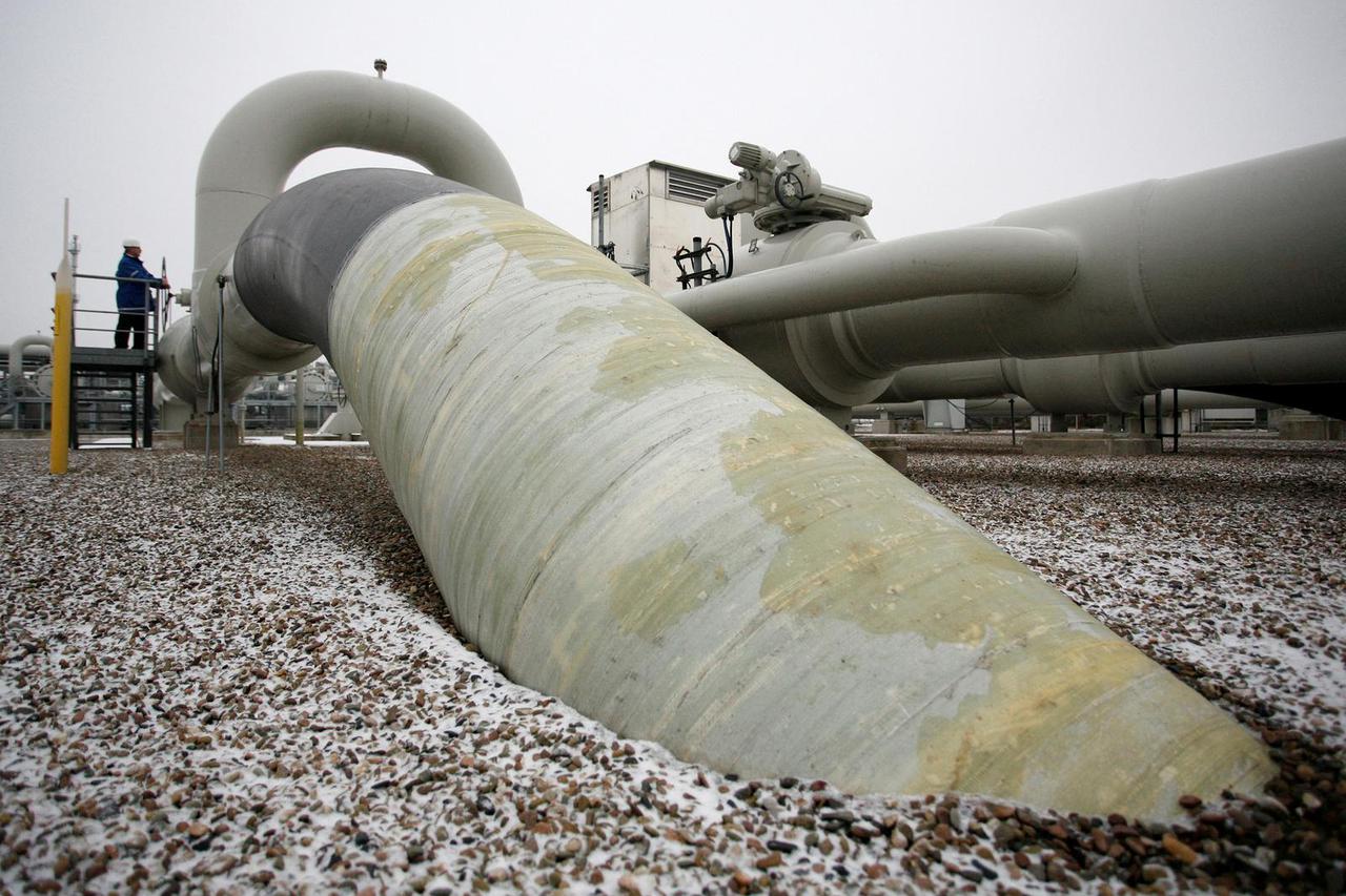 FILE PHOTO: A technician stands beside a gas pipe at the WINGAS gas storage facility near the northern German town of Rehden