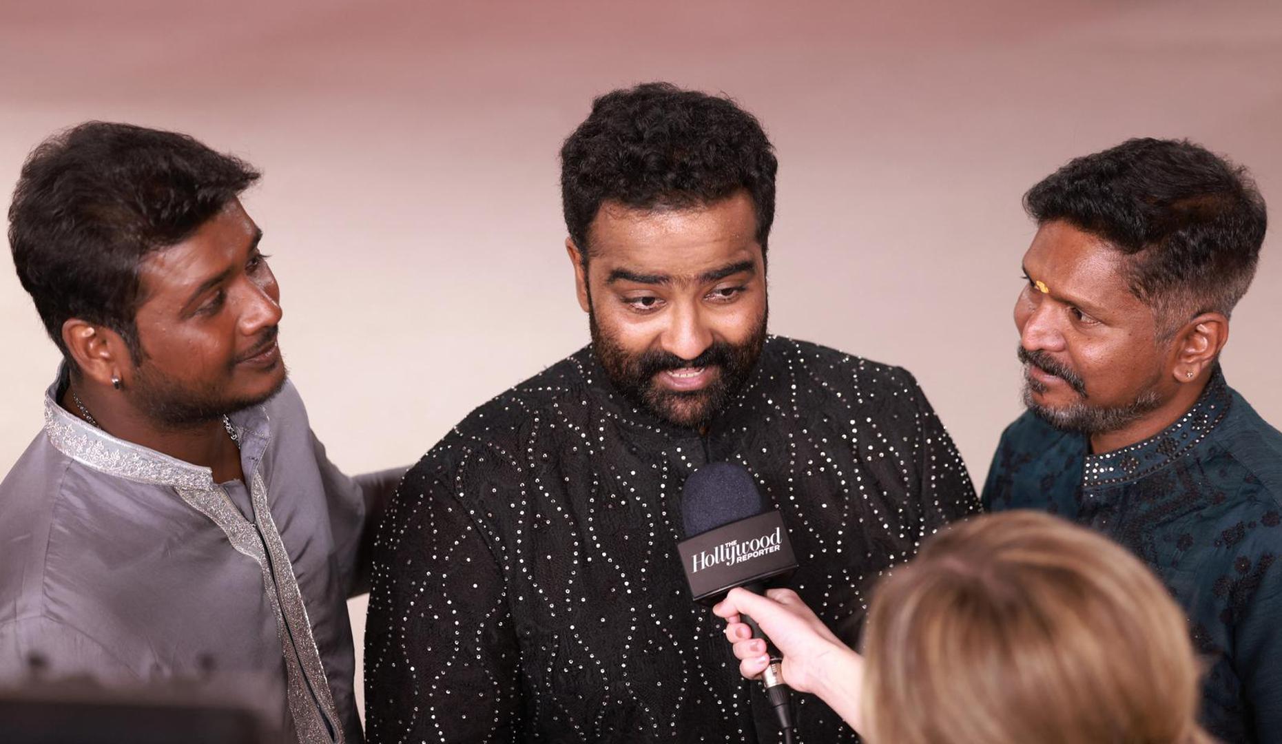 Rahul Sipligunj, Kaala Bhairava and choreographer Prem Rakshith talk to a reporter on the champagne-colored red carpet during the Oscars arrivals at the 95th Academy Awards in Hollywood, Los Angeles, California, U.S., March 12, 2023. REUTERS/Aude Guerrucci Photo: Aude Guerrucci/REUTERS