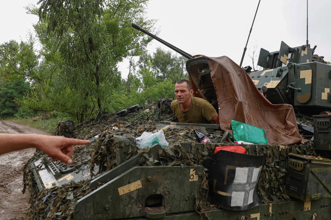 Ukrainian serviceman sits inisde a M2 Bradley infantry fighting vehicle at a position near a front line in Zaporizhzhia region