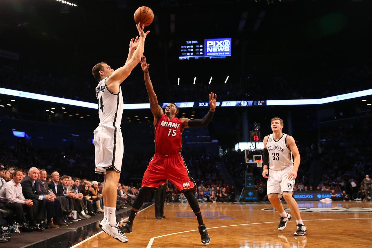 Nov 17, 2014; Brooklyn, NY, USA; Brooklyn Nets guard Bojan Bogdanovic (44) shoots for three over Miami Heat guard Mario Chalmers (15) during the third quarter at Barclays Center. Miami Heat won 95-83. Mandatory Credit: Anthony Gruppuso-USA TODAY Sports