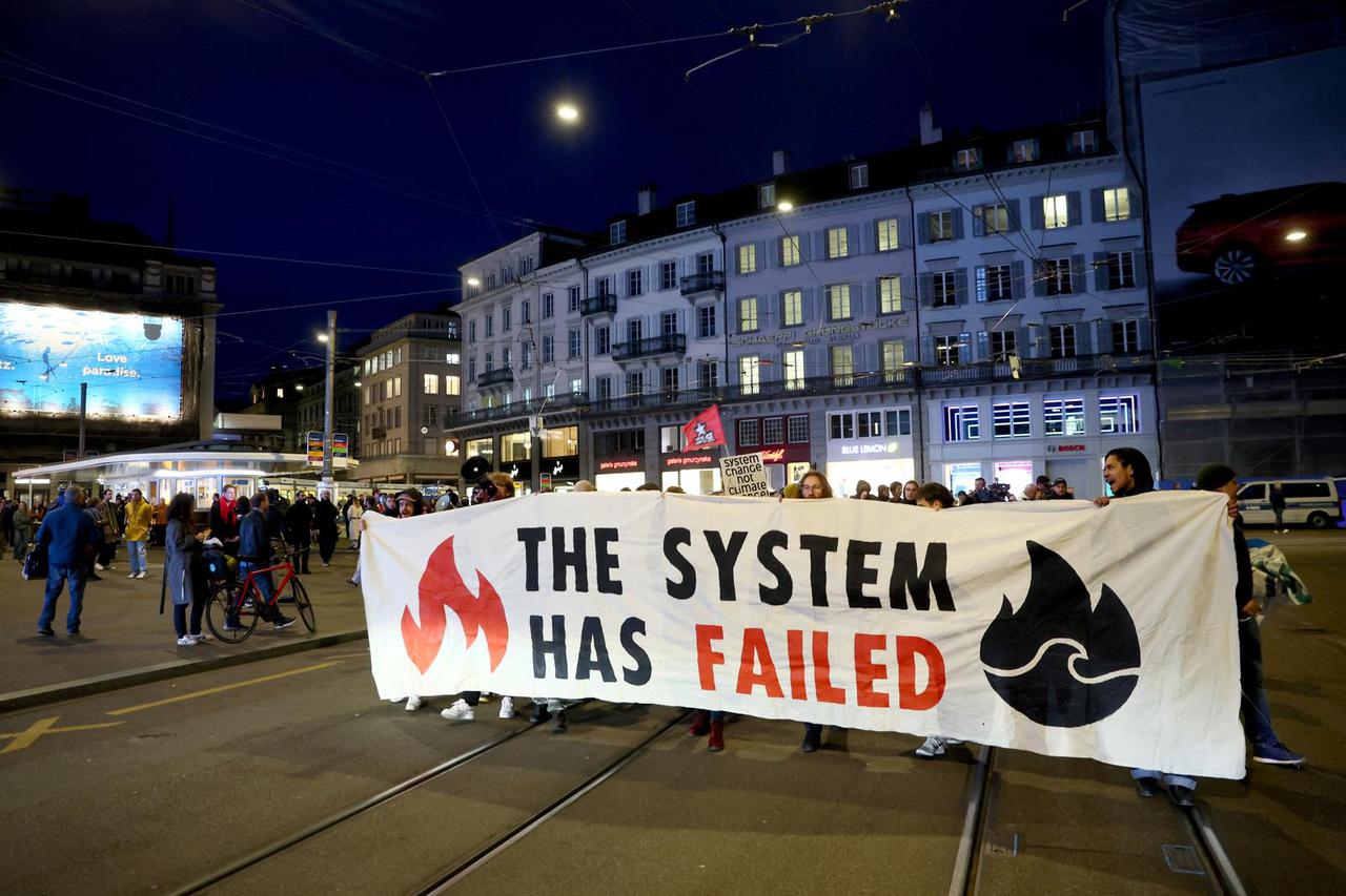 FILE PHOTO: People demonstrate against the buying of Swiss bank Credit Suisse by UBS, in Zurich