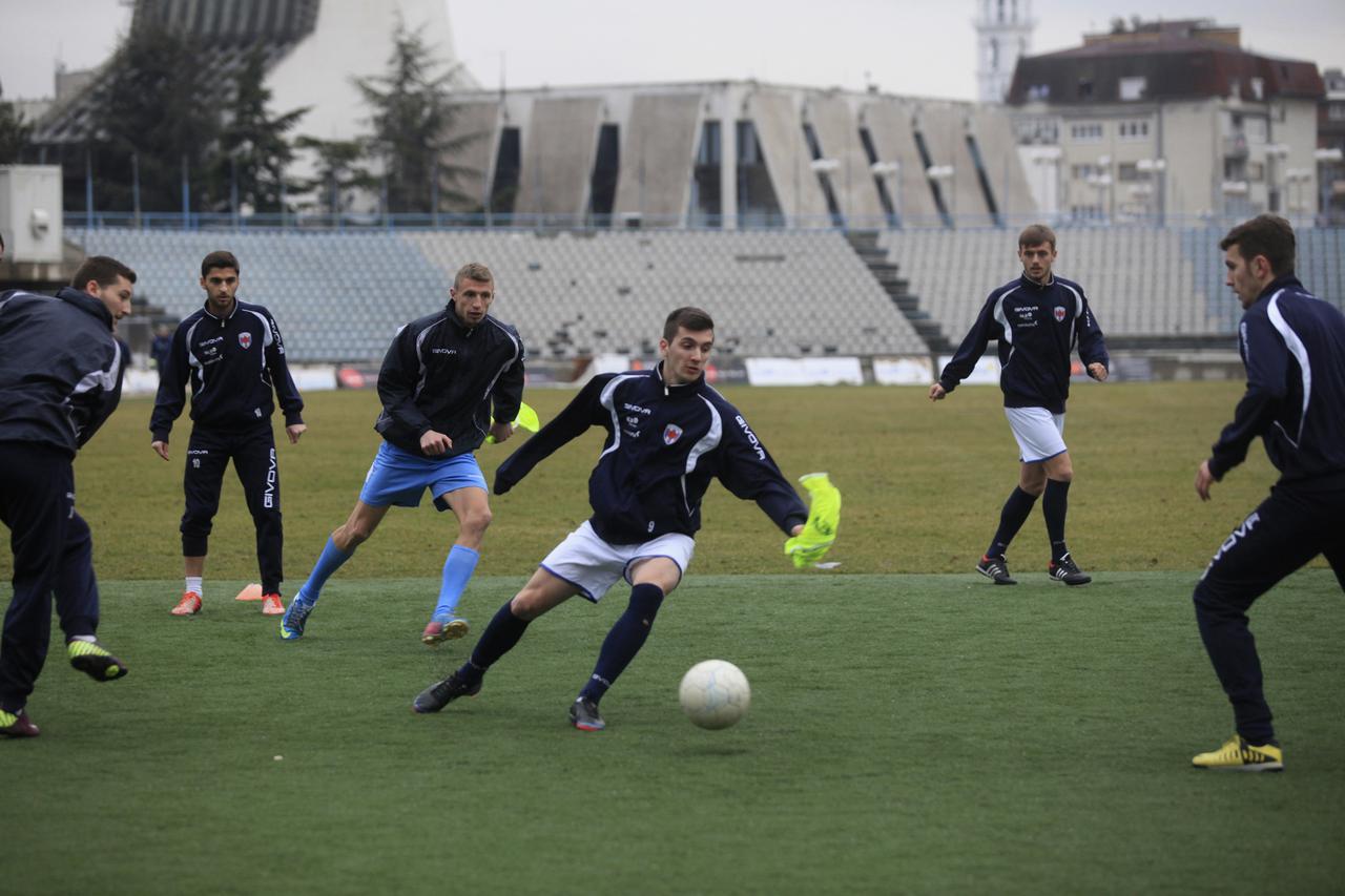 Kosovar football players train at the Pristina stadium in Kosovo January 22, 2014. Striking a compromise, the footballing body FIFA ruled last week that Kosovo may play friendly internationals, without national symbols or the Kosovo national anthem. Nor w