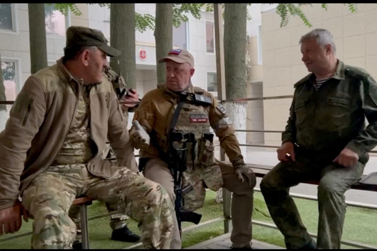 FILE PHOTO: Founder of Wagner private mercenary group Yevgeny Prigozhin and Russian Wagner Group fighters at the headquarters of the Southern Military District of the Russian Armed Forces in Rostov-on-Don