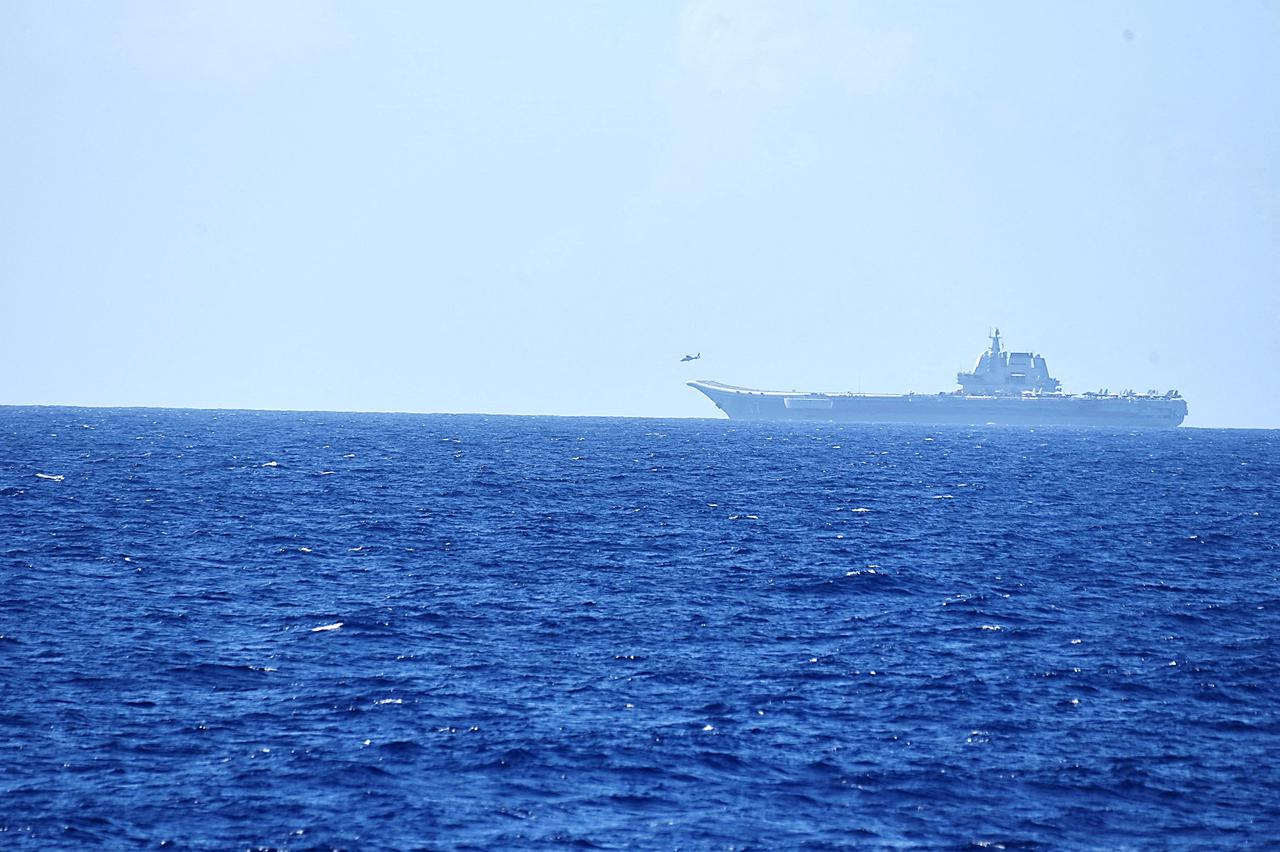 FILE PHOTO: A helicopter takes off from China's Shandong aircraft carrier, over Pacific Ocean waters, south of Okinawa prefecture