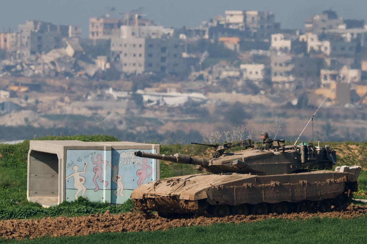 An Israeli tank manoeuvres along the northern Gaza Strip border